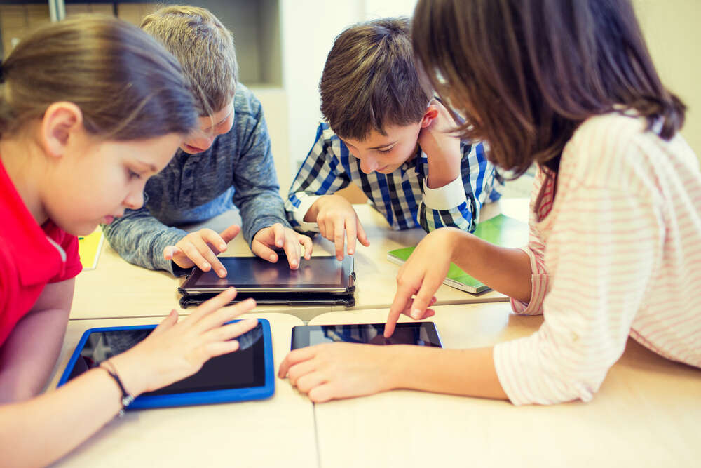 Children in school using ipads