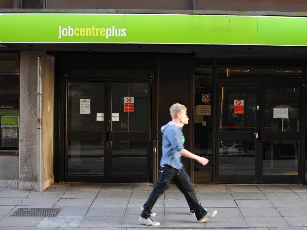 A person walking in front of a JobCentre in
