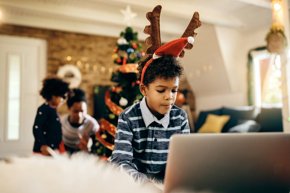 Boy using laptop at Christmas