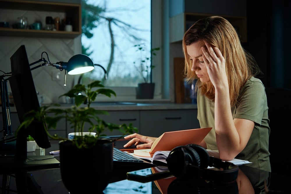Woman working late at a laptop at home