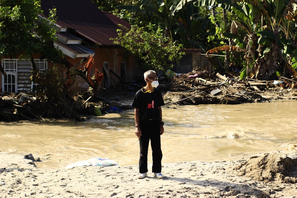 Man standing in flood in Masamba, Indonesia