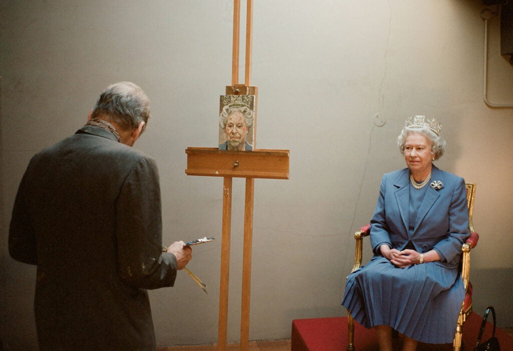 Queen Elizabeth II posing for a portrait painted by Lucian Freud