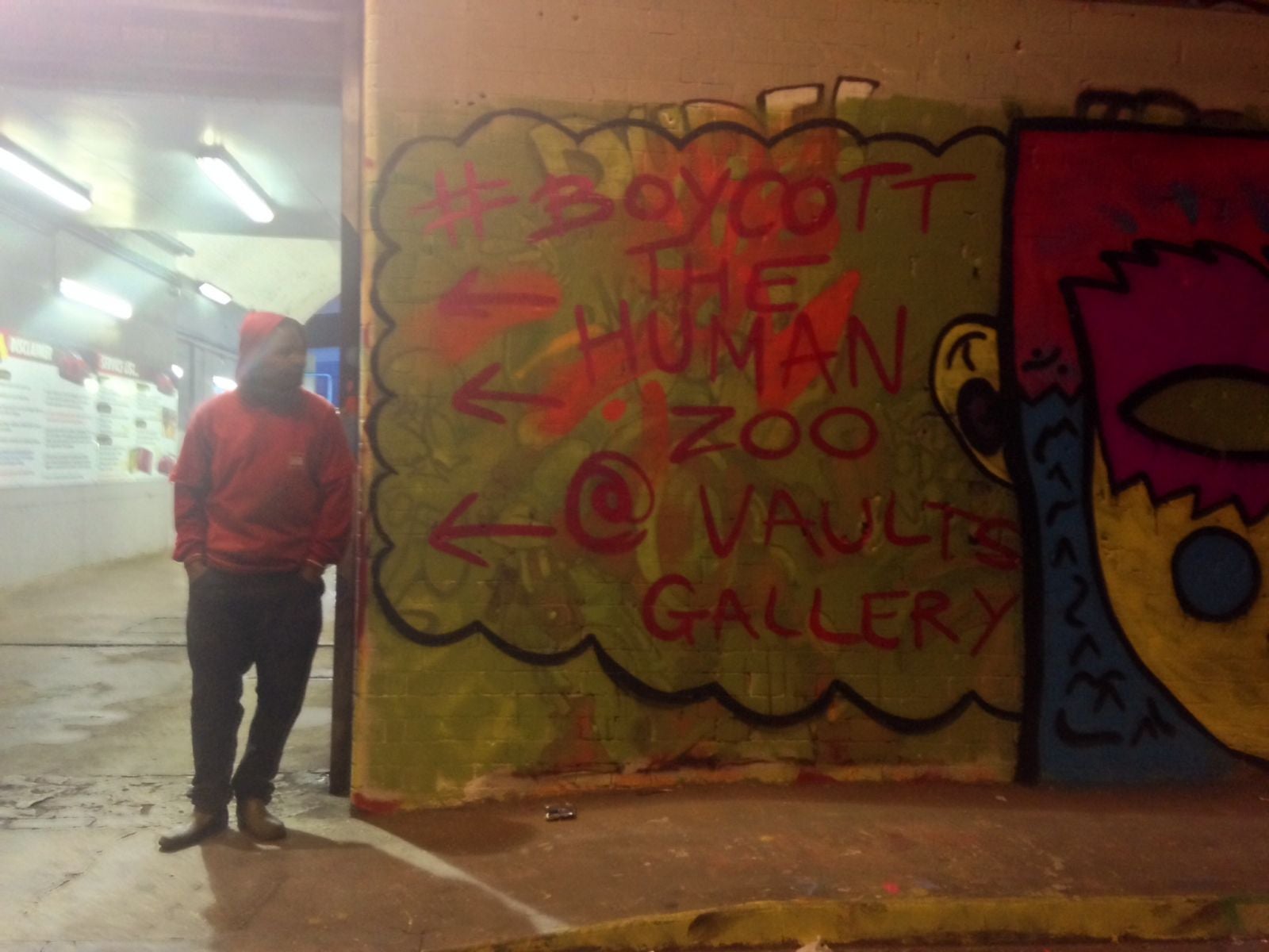 Graffiti on the walls of the underpath leading to the Vaults reads "Boycott the Human Zoo @ Vaults Gallery"